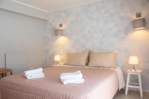 a bedroom with a bed with two towels on it at Charming House in Requião with Shared Pool in Requião