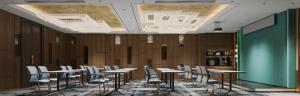 a row of tables and chairs in a room at Phoenix Crowne Vinh Hotel in Vinh +54 photos