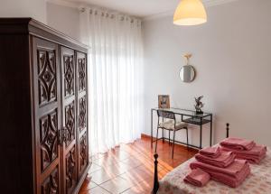 a bedroom with a bed with a table and a dresser at Apartment with Mountain View in Eiriz – 65 sqm – Terrace in Eiriz