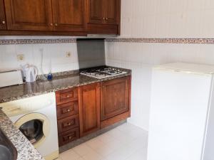 a kitchen with a stove and a washing machine at Apartment with Mountain View in Eiriz – 65 sqm – Terrace in Eiriz