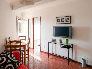 a living room with a tv and a table at Apartment with Mountain View in Eiriz – 65 sqm – Terrace in Eiriz