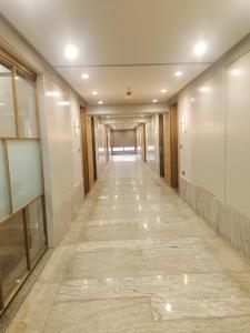 a hallway of a building with a long corridor at Umbrellaa Hotels in Ahmedabad +1 photo
