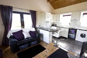 a kitchen with a couch and a table in a room at Cill Cottage in Roundstone