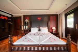 a bedroom with a large bed with red hearts on it at Sunshine Golden Cruises in Cat Ba