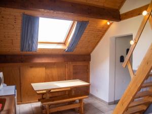 a room with a table and a window at Appartement chaleureux à Gresse-en-Vercors 43 m² vue montagne in Gresse-en-Vercors