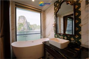 a bathroom with a sink and a large window at Sunshine Golden Cruises in Cat Ba
