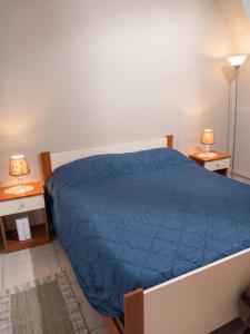 a bedroom with a blue bed and two night stands at Modern Studio in Catania with Air Conditioning in Catania