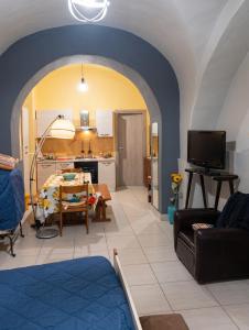 a living room with a table and a kitchen at Modern Studio in Catania with Air Conditioning in Catania