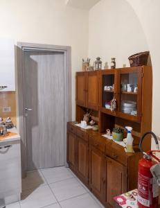 a kitchen with wooden cabinets and a door open at Modern Studio in Catania with Air Conditioning in Catania