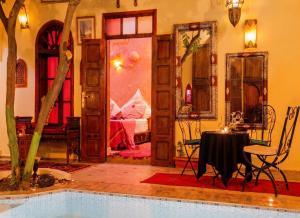 a living room with a pool and a bedroom at Exceptional Villa in Marrakech with Private Pool in Marrakesh