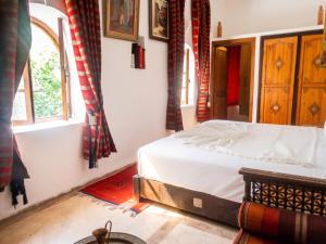 a bedroom with a bed in a room with a window at Exceptional Villa in Marrakech with Private Pool in Marrakesh