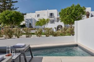 a swimming pool in front of a white building at Naxos Resort in Naxos Chora
