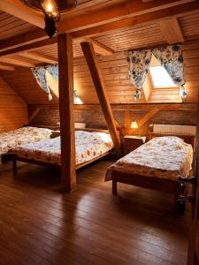 a bedroom with two beds in a wooden cabin at House of Aurora in Šwidnik +53 photos