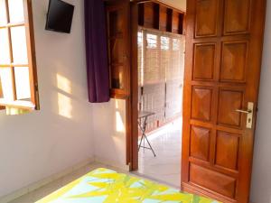 a room with a door and a bed and a window at Studio charmant à Sainte-Anne, 23 m², piscine partagée in Sainte-Anne +10 photos