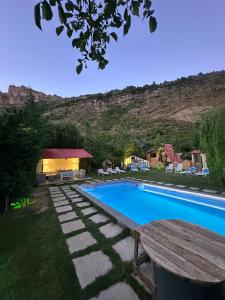a swimming pool in a yard with a picnic table at arida farm peach in Bcharré