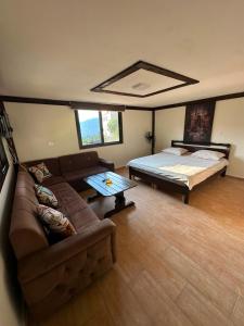 a living room with a couch and a bed at arida farm peach in Bcharré