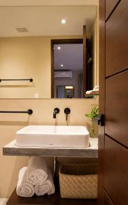 a bathroom with a sink and a mirror at Hotel Alto Monte Hacienda & Spa - Only Adults in Chiguirí Arriba +33 photos