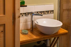 a bathroom sink with a faucet on a wooden counter at Gîte La Peyrolle in Aouste-sur-Sye +21 photos
