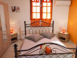 a bedroom with a black bed with two tables at Appartement moderne avec vue mer à Bouillante, 50 m² in Bouillante