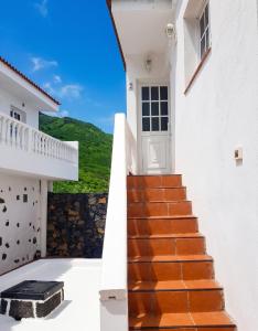a stairway leading to a white house with a door at Cosy Studio with Sea View and Garden in Frontera - 20 m² in Frontera
