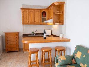 a kitchen with a counter and a kitchen island with stools at Exceptional Studio in Frontera | 25 sq.m. | Terrace in Frontera +18 photos