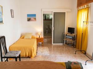 a bedroom with a bed and a television in a room at Exceptional Studio in Frontera | 25 sq.m. | Terrace in Frontera