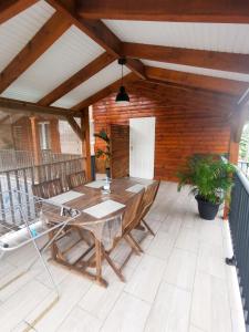 a patio with a wooden table and chairs at Studio cosy à Capesterre-Belle-Eau avec terrasse in Capesterre-Belle-Eau