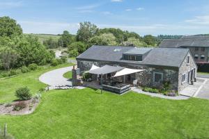 an aerial view of a stone house with a lawn at Une parenthèse en Ardenne in Nollevaux