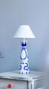 a blue and white lamp sitting on top of a table at "LOS" 2 Neoclassic Harbour View in Symi +29 photos