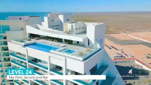a building with a swimming pool on top of it at Encantame Velero Ground Floor, BeachFront in Playa Encanto