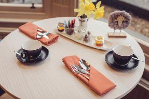 a table with two cups and a tray with utensils at Ambleside Fell Rooms in Ambleside