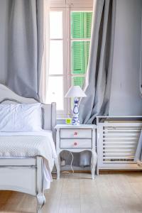 a bedroom with two beds and a table with a lamp at "LOS" 2 Neoclassic Harbour View in Symi