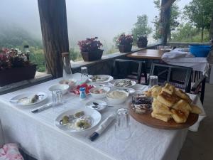 a table with a plate of food on it at A&R cottages in Vusanje
