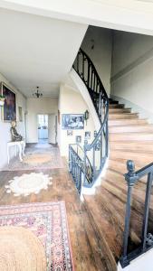 a room with a staircase and a rug at L'héritage in Champdeniers