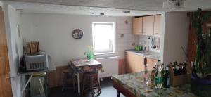 a small kitchen with a table and a window at Pension Pencik in Kurort Altenberg +11 photos