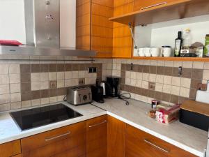 a kitchen with wooden cabinets and a sink at Lazaros in Ágios Matthaíos