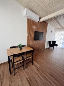 a dining room with a table and a tv in a room at בצלי-ה in Safed