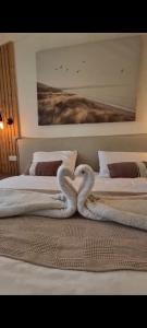 a swan made to look like a heart on a bed at בצלי-ה in Safed
