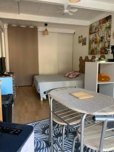 a room with a bed and a table in it at Studio indépendant avec terrasse et jardin au calme chez Pascale in Saint-Clément-de-Rivière