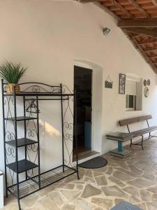 a living room with a bench and a table at Studio indépendant avec terrasse et jardin au calme chez Pascale in Saint-Clément-de-Rivière +16 photos