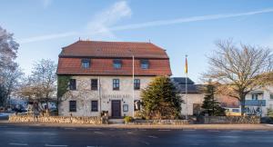 a large building with a red roof on a street at Leipziger Hof in Fulda