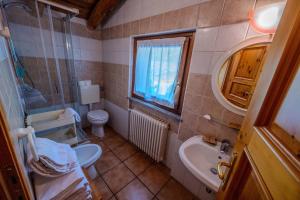 a bathroom with a sink and a toilet and a window at Residence Trompe-L'oeil in Champoluc +50 photos