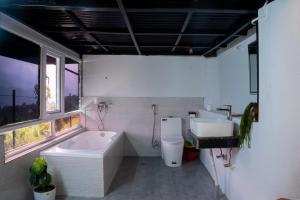 a bathroom with a large tub and a sink at The Edge Villa & Retreat in Pokhara