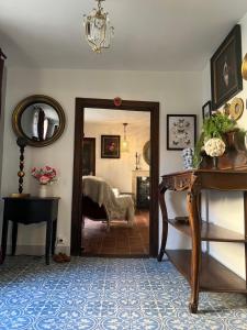 a room with a mirror and a room with a bed at La Clé D'Alice in Montmorillon