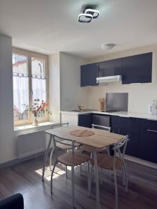 a kitchen with a table and chairs in a kitchen at T2 calme rue Pasteur appartement 1 - DABNB in Le Palais-sur-Vienne