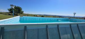 a large swimming pool on top of a building at Pensiunea Gernik 100 in Gârnic