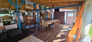 a room with a table and chairs in a house at Pensiunea Gernik 100 in Gârnic