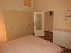 a bedroom with a bed and a closet and a mirror at B&B Campisi Anna in Altamura