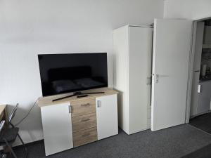 a flat screen tv sitting on top of a cabinet at Soleil et me in Burgtiefe auf Fehmarn 