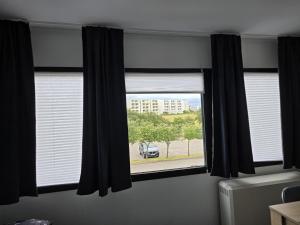 a window with black curtains in a room at Soleil et me in Burgtiefe auf Fehmarn 
